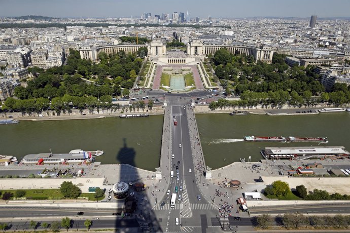 The Eiffel Tower casts its shadow on the Seine River next to the Iena bridge and