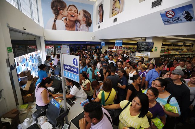 People line up to buy hygienic products inside a Farmatodo drugstore in Caracas