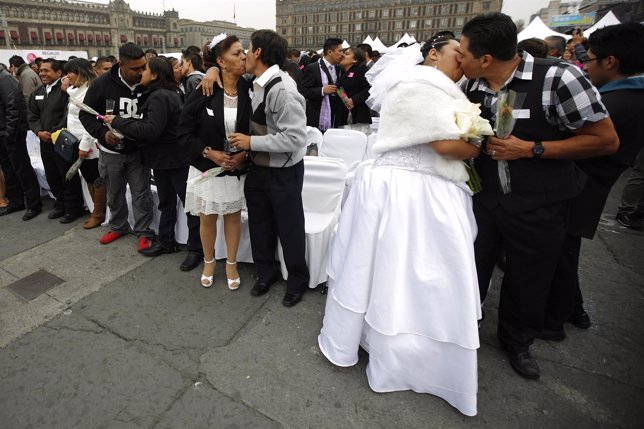 Couples kiss during a mass wedding at Zocalo square in Mexico City