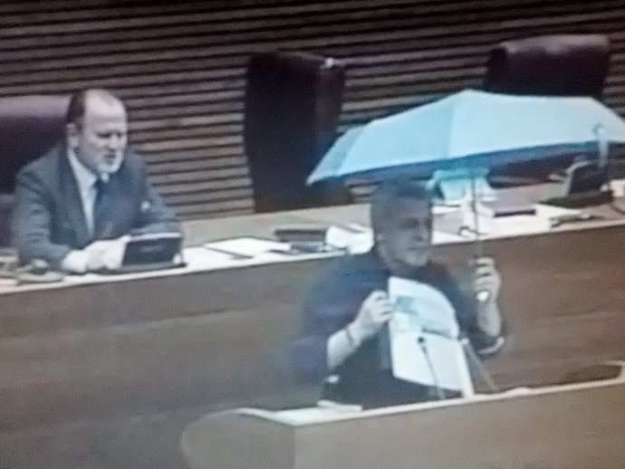 Soto (PSPV) abre un paraguas en el pleno de las Corts.