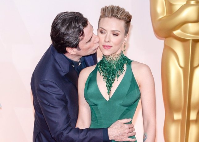 Actor John Travolta hugs Scarlett Johansson at the 87th Annual Academy Awards he