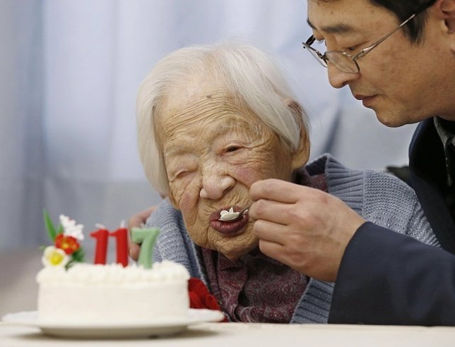Japanese Okawa, the world's oldest living person, is helped to eat her birthday 