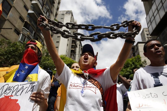 Opposition supporters shout during a gathering to protest against Venezuelan gov