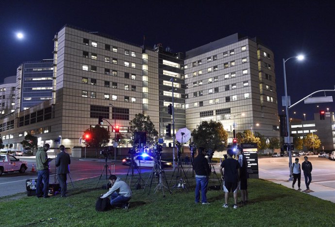 Members of the media wait outside The Ronald Reagan UCLA Medical Center, where a