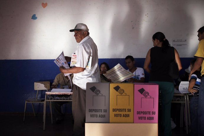 A man prepares to cast his vote during the municipal and parliamentary elections
