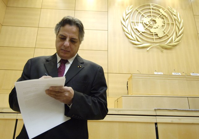 Cuadros, Chairman of the UN Human Rights Commission, writes notes before the pos