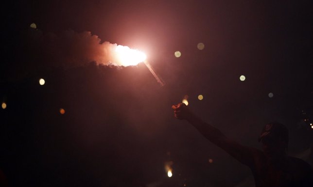 A fan of Argentina's River Plate celebrates with a flare at the start of their C