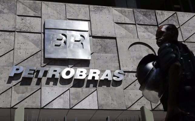 A policeman stands in front of the Petrobras headquarters during a protest in Ri