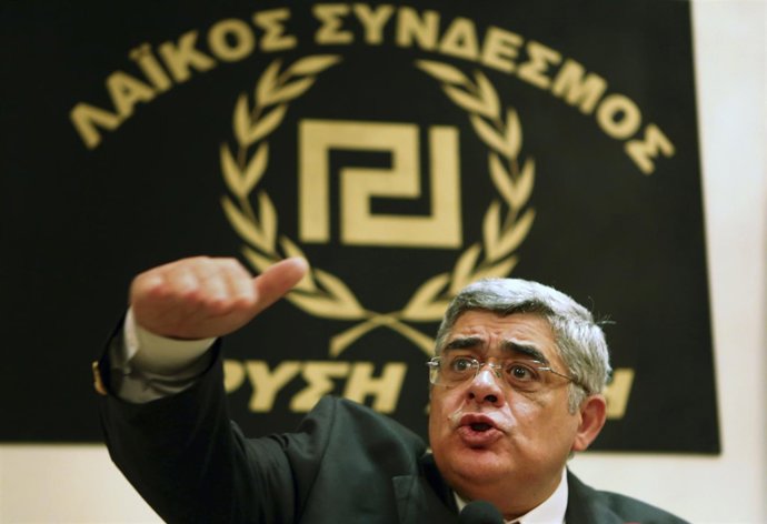 Leader of extreme-right Golden Dawn party Mihaloliakos talks to reporters at a n