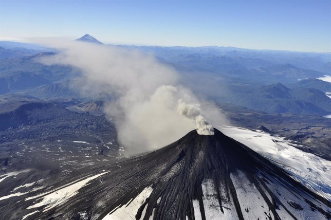 An aerial view shows smoke and ash rising from Villarrica Volcano, south of Sant