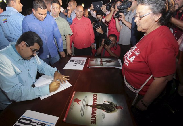 Venezuela's President Nicolas Maduro signs a public petition against U.S. Sancti