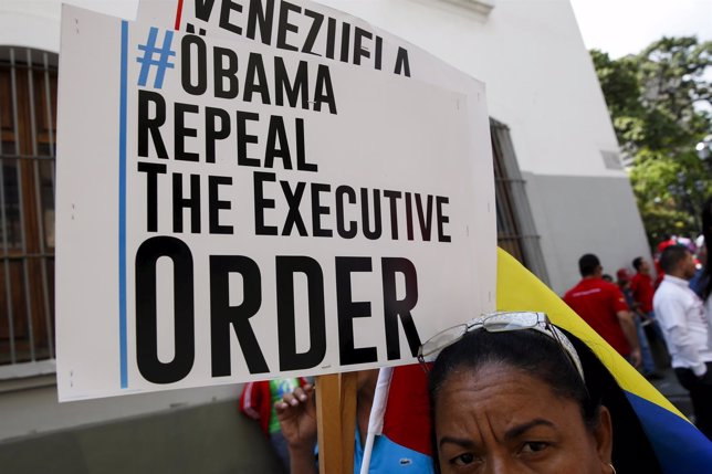 Supporter of Venezuela's President Maduro holds a placard during a protest again