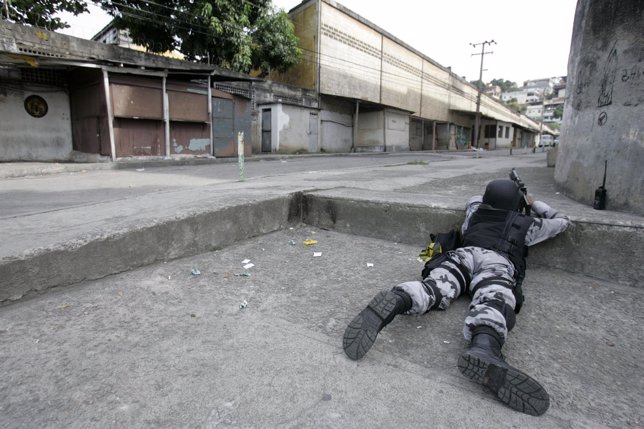 A member of the National Anticrime Force takes up position during an operation a