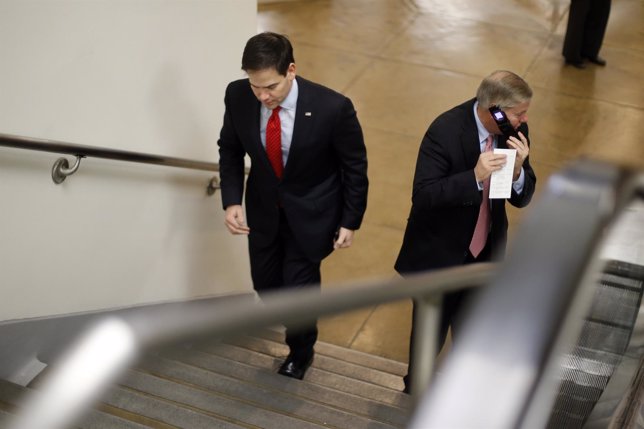Rubio and Graham cross paths as they arrive for a vote on whether to overturn a 