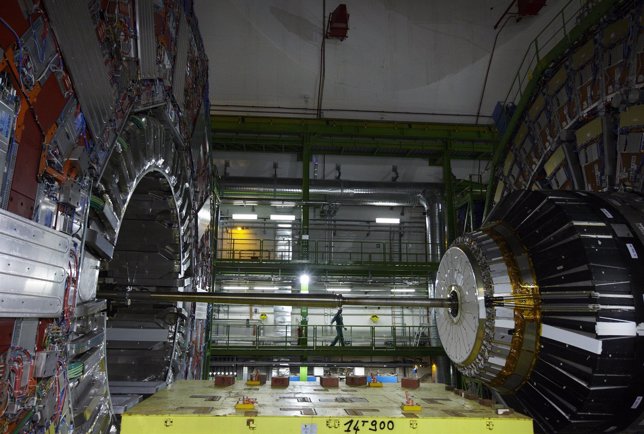 A technician stands near equipment of the CMS experience at the CERN in Cessy