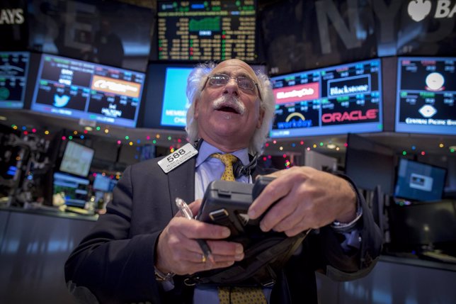 Trader Peter Tuchman watches the Dow Jones Industrial average just before the cl