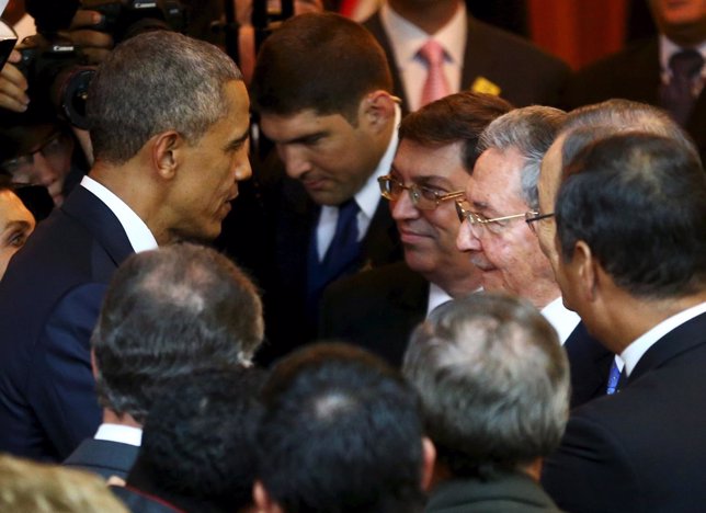 U.S. President Barack Obama talks with his Cuban counterpart Raul Castro before 