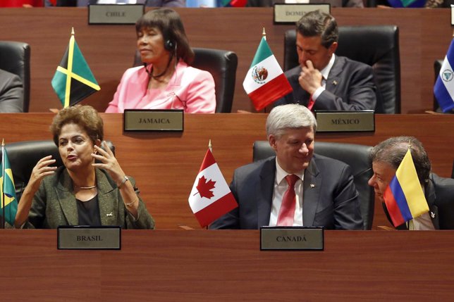 Rousseff, Harper and Santos talk during the inauguration ceremony of Summit of t