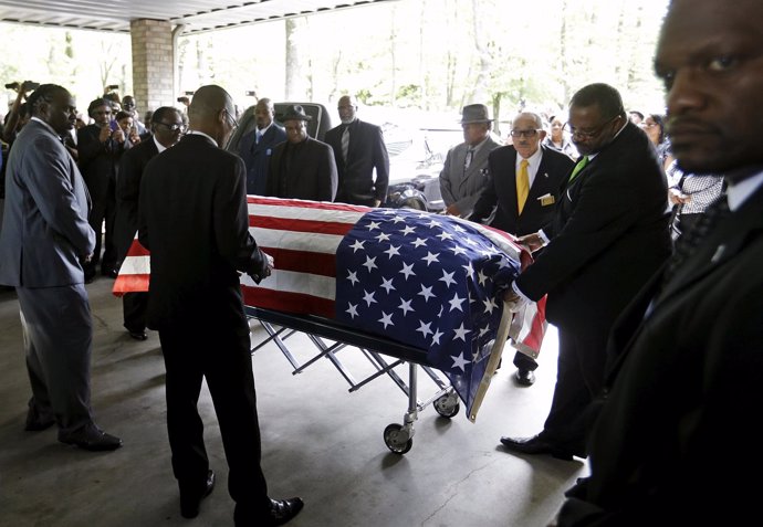 The casket of Walter Scott is wheeled into W.O.R.D. Ministries Christian Center 