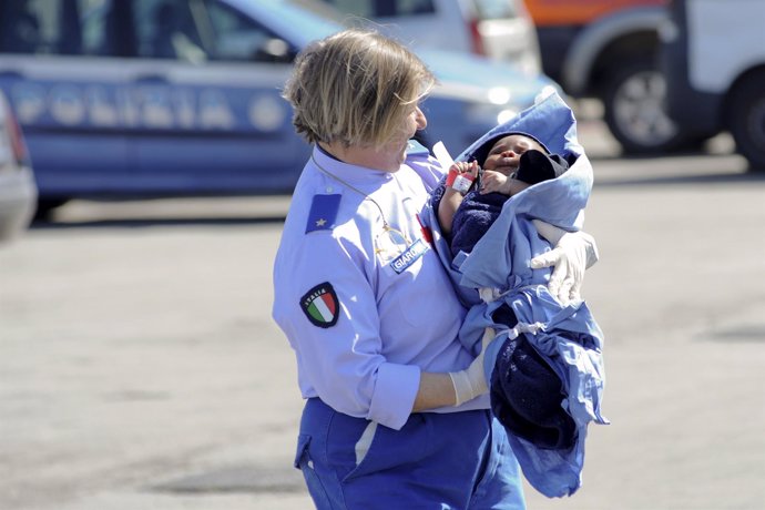 Una enfermera de Cruz Roja con un bebé inmigrante