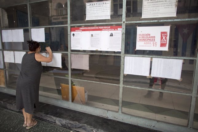 A woman looks through the window of a polling station to be used for the municip