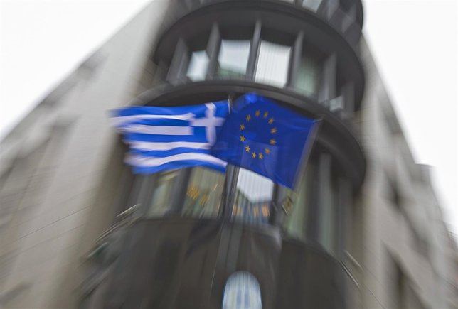 Greek national flag and a European Union flag flutter outside the Greek embassy 