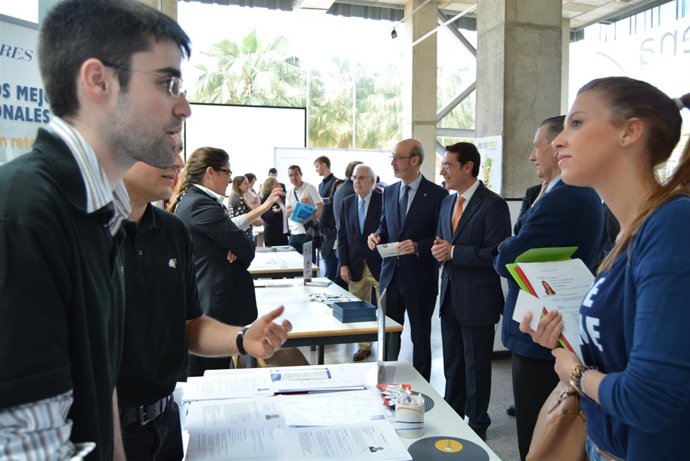 Un estudiante de la UPCT atiende a una asistente al Foro