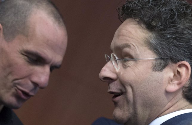 Greek Finance Minister Varoufakis walks past  Eurogroup Chairman Dijsselbloem at
