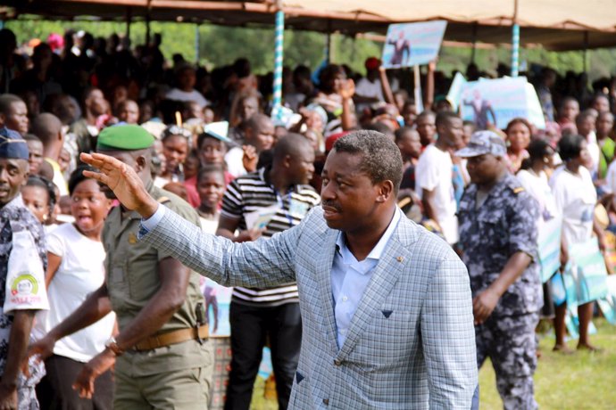 Incumbent presidential candidate Faure Gnassingbe waves to a crowd at a campaign