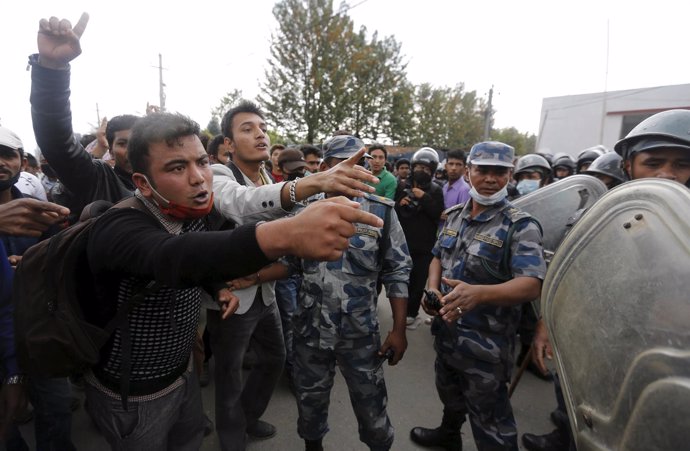 Earthquake victims argue with policemen during a protest against the government'