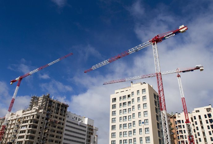 Cranes tower over apartment blocks under construction outside Madrid