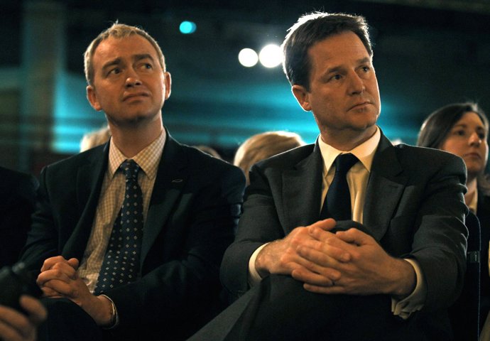 Nick Clegg, leader of Britain's Liberal Democrats sits with party president Tim 