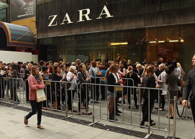 Shoppers queue outside Zara as it opens the doors