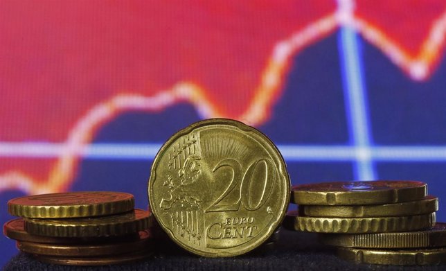 Euro coins are seen in front of displayed stock graph in this picture illustrati
