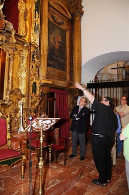 Fuentes (al fondo, izda.) observa el retablo