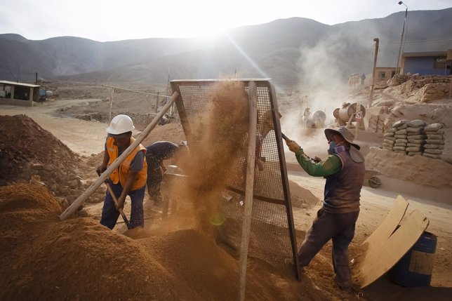 Miners from Aurelsa mining company strain stones containing gold materials at th