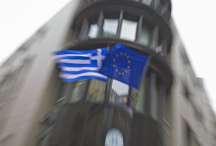 Greek national flag and a European Union flag flutter outside the Greek embassy 