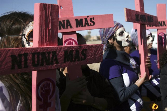 Members of the human rights organisation hold wooden crosses in Ciudad