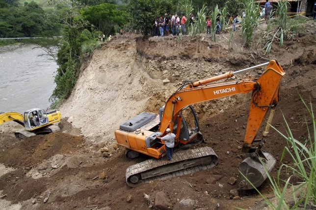 A digger works close to the Cauca river to remove land as part of the rescue of 