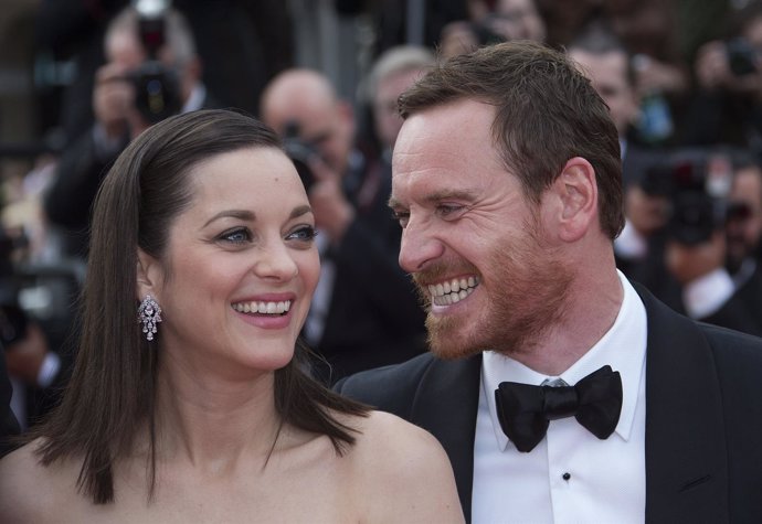 Cast members Marion Cotillard and Michael Fassbender pose on the red carpet as t