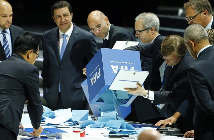 FIFA staff empty ballot boxes after the first round of the election to decide th