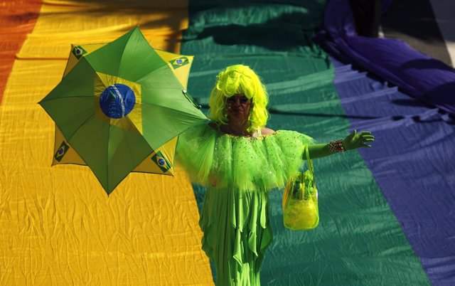 A participant holding an umbrella takes part in a Gay Pride Parade on Copacabana