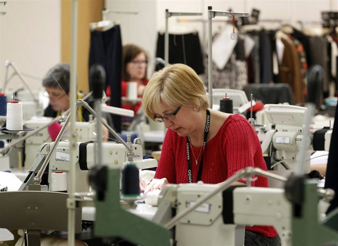 Employees sew on machines at a clothing factory of Spanish textile retailer Mang