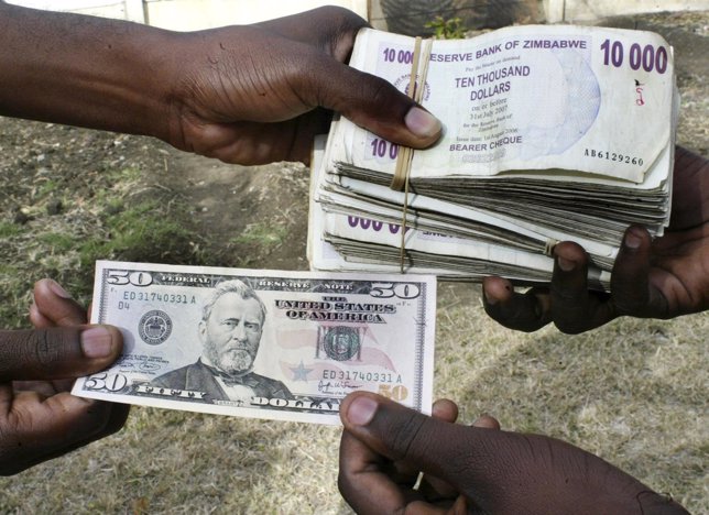 Black market currency traders exchange U.S. And Zimbabwean bank notes in the cap