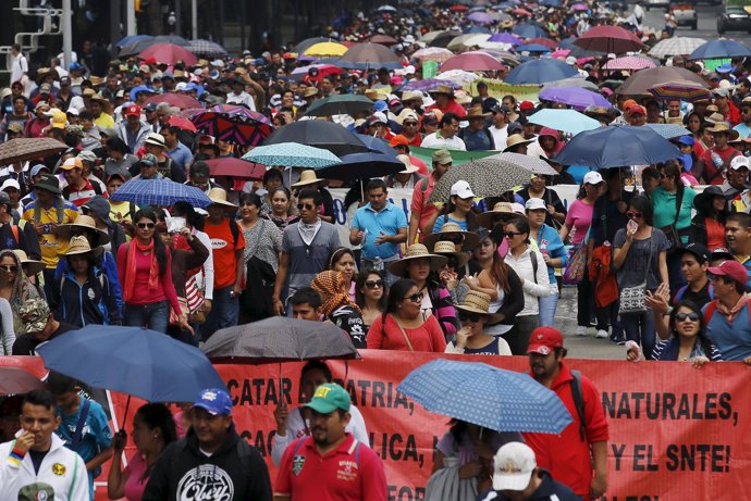 Members of the teacher's union CNTE take part in a march along Reforma Avenue in