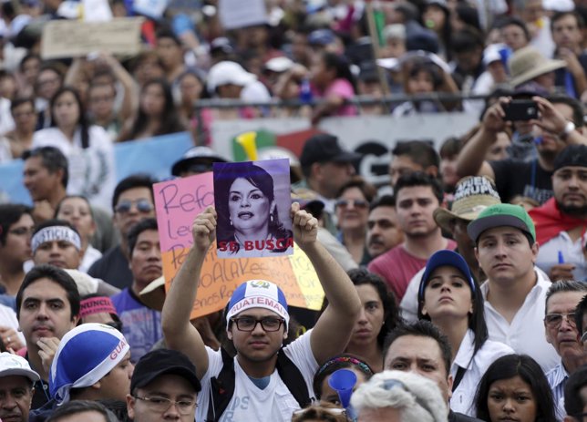 A protester holds picture with image of former Guatemalan vice president Roxana 