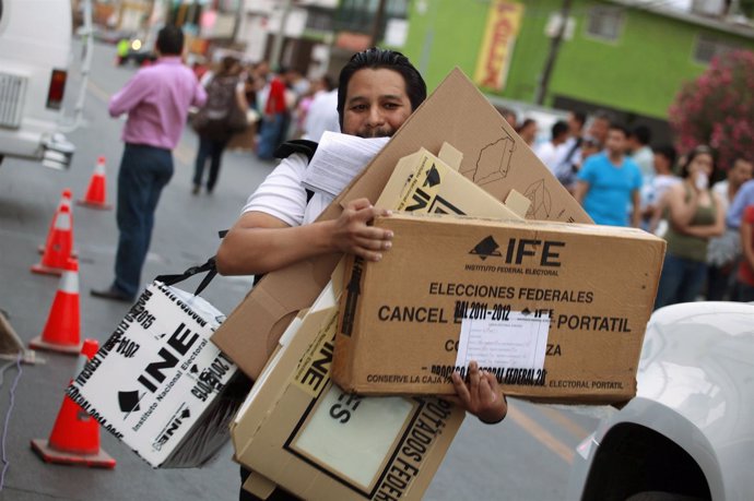 Election official carries ballot boxes and voting materials in Ciudad Juarez