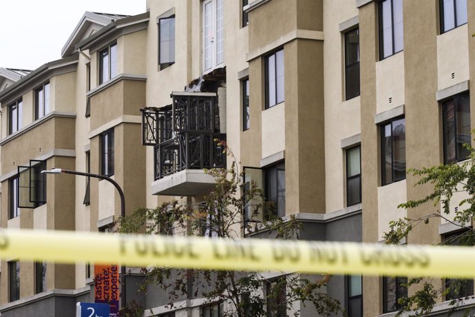 Damage is seen at the scene of a 4th-story apartment building balcony collapse i