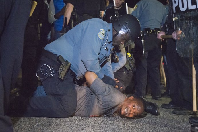Police arrest a protester outside the City of Ferguson.
