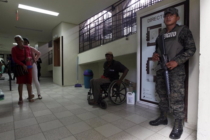 Soldier stands guard as patients are seen at San Felipe hospital in Tegucigalpa